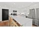 Bright, updated kitchen features stainless steel appliances, white cabinetry, and a large island with seating at 5055 Gulf Of Mexico Dr # 115, Longboat Key, FL 34228
