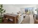 Bright living room with a comfortable sofa, two chairs, a modern coffee table, and shutters on the large window at 5055 Gulf Of Mexico Dr # 115, Longboat Key, FL 34228