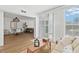 Open living room and dining area with modern finishes, natural light, and wood-style flooring at 5055 Gulf Of Mexico Dr # 115, Longboat Key, FL 34228