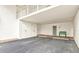 Covered parking area with two storage closets, assigned parking spots and a green bench at 5055 Gulf Of Mexico Dr # 115, Longboat Key, FL 34228