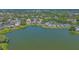 A serene waterfront property features lush landscaping and a tranquil lake view at 515 Spring Lakes Blvd # 515, Bradenton, FL 34210