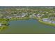 A serene waterfront property features lush landscaping and a tranquil lake view at 515 Spring Lakes Blvd # 515, Bradenton, FL 34210