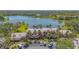 Aerial view of the community and lake, showcasing lush trees, waterfront location, and well-maintained buildings at 515 Spring Lakes Blvd # 515, Bradenton, FL 34210