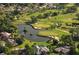 Scenic aerial view capturing the expansive golf course with lush greenery, water features, and surrounding residences at 515 Spring Lakes Blvd # 515, Bradenton, FL 34210