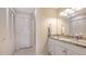 Bright bathroom featuring a granite countertop, white cabinets, and convenient built-in storage at 515 Spring Lakes Blvd # 515, Bradenton, FL 34210
