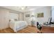 Comfortable bedroom showcasing light wood floors, murphy bed, and built-in wardrobes and desk at 515 Spring Lakes Blvd # 515, Bradenton, FL 34210