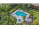 Aerial view of a community pool and spa surrounded by lush landscaping at 515 Spring Lakes Blvd # 515, Bradenton, FL 34210