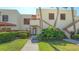 Inviting condo entrance with a well-manicured lawn and colorful landscaping at 515 Spring Lakes Blvd # 515, Bradenton, FL 34210