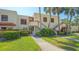 Exterior view of a building featuring well-maintained landscaping, mature plants, and walkway at 515 Spring Lakes Blvd # 515, Bradenton, FL 34210