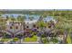 Exterior view showcasing the community buildings, a lake in the background, and mature landscaping at 515 Spring Lakes Blvd # 515, Bradenton, FL 34210
