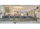 Open-concept kitchen featuring a breakfast bar and views of the living room and lake, great for entertaining at 515 Spring Lakes Blvd # 515, Bradenton, FL 34210