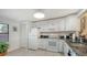 Well-lit kitchen with white cabinetry, granite countertops, and modern appliances, offering both style and functionality at 515 Spring Lakes Blvd # 515, Bradenton, FL 34210