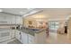 Open concept kitchen with granite counters, seamlessly flowing into the living and dining areas with a beautiful water view at 515 Spring Lakes Blvd # 515, Bradenton, FL 34210