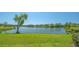 Serene lake view with lush green lawn, mature trees, and the peaceful waterfront at 515 Spring Lakes Blvd # 515, Bradenton, FL 34210