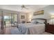 Well-lit main bedroom with sliding doors leading to the sun room and serene views of the lake at 515 Spring Lakes Blvd # 515, Bradenton, FL 34210