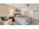 Bright and airy main bedroom featuring a sunset art piece and a sliding door to the sun room at 515 Spring Lakes Blvd # 515, Bradenton, FL 34210