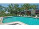 A beautiful clear blue pool with lounge chairs and plenty of trees and bushes around the deck at 515 Spring Lakes Blvd # 515, Bradenton, FL 34210