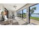 Spacious sun room has a seating area and floor-to-ceiling windows with stunning views of the lake and landscaping at 515 Spring Lakes Blvd # 515, Bradenton, FL 34210