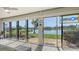 Inviting sun room with sliding glass doors that offer beautiful views of the lake and meticulously maintained landscape at 515 Spring Lakes Blvd # 515, Bradenton, FL 34210