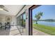 Sun room showcases a dining area with large windows framing picturesque views of the lake at 515 Spring Lakes Blvd # 515, Bradenton, FL 34210