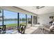 Bright sun room offering seating and large windows with beautiful panoramic views of the lake at 515 Spring Lakes Blvd # 515, Bradenton, FL 34210