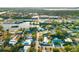 Birds eye view of residential community with water views surrounded by lush green trees at 5247 Carmilfra Dr, Sarasota, FL 34231