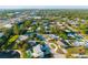 An aerial view showcases a community with lush greenery, a mix of home styles, and easy access to nearby amenities at 5247 Carmilfra Dr, Sarasota, FL 34231