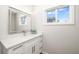 Modern bathroom with sleek vanity, illuminated mirror, and ample natural light at 5247 Carmilfra Dr, Sarasota, FL 34231