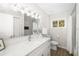 Bright bathroom with a white marble countertop, modern fixtures, and a tiled shower at 5247 Carmilfra Dr, Sarasota, FL 34231