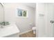 Modern bathroom featuring a walk-in shower with sleek design, white tile and gray walls, with a clean design at 5247 Carmilfra Dr, Sarasota, FL 34231