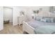 Comfortable bedroom with neutral tones, plush bedding, and a classic wooden dresser, creating a peaceful retreat at 5247 Carmilfra Dr, Sarasota, FL 34231