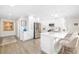 Modern kitchen with stainless steel appliances, white cabinetry, and a breakfast bar with stylish seating at 5247 Carmilfra Dr, Sarasota, FL 34231