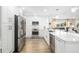 Modern kitchen seamlessly integrates with the living area, featuring stainless steel appliances and a bright, open layout at 5247 Carmilfra Dr, Sarasota, FL 34231