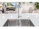 Modern kitchen featuring stainless steel sink, chrome faucet and bright quartz countertops with an open concept view at 5247 Carmilfra Dr, Sarasota, FL 34231