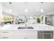 Spacious kitchen island with stainless steel features, modern sink, and a seamless view into the living area at 5247 Carmilfra Dr, Sarasota, FL 34231
