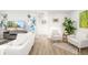 Cozy living room with neutral tones, modern decor, light wood floors, and bright artwork at 5247 Carmilfra Dr, Sarasota, FL 34231