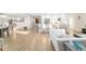 Open-concept living space with sleek floors, modern furniture, and a stylish kitchen island with bar seating at 5247 Carmilfra Dr, Sarasota, FL 34231