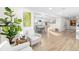 Bright living space with wood floors, a view into the dining room, and decorative plants at 5247 Carmilfra Dr, Sarasota, FL 34231