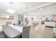 Bright, open-concept living and dining area with modern decor, light wood floors, and recessed lighting at 5247 Carmilfra Dr, Sarasota, FL 34231