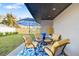 Outdoor patio area with colorful decor, complete with umbrella, table, and chairs at 5247 Carmilfra Dr, Sarasota, FL 34231