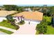 Aerial view of a pink single-story home with an orange roof and a spacious three-car garage at 5270 Far Oak Cir, Sarasota, FL 34238