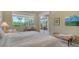 Bright bedroom with neutral walls, large window, and wooden furniture creating a cozy and inviting space at 5270 Far Oak Cir, Sarasota, FL 34238