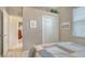 Bright bedroom with closet, neutral walls, and a view to another room at 5270 Far Oak Cir, Sarasota, FL 34238