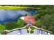 An aerial view of the clubhouse showcases its architectural design with a red tile roof, lush greenery, and convenient parking at 5270 Far Oak Cir, Sarasota, FL 34238