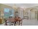 Elegant dining room featuring a large table, chandelier, and windows with shutters providing natural light at 5270 Far Oak Cir, Sarasota, FL 34238