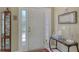 Bright foyer featuring an entry door with sidelights, a glass-top table, and a decorative mirror at 5270 Far Oak Cir, Sarasota, FL 34238