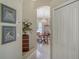 Inviting hallway with elegant chandelier, leading into the dining room and featuring decoratively framed artwork at 5270 Far Oak Cir, Sarasota, FL 34238