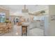 Open-concept living and kitchen area with white cabinets, tile floors and eat-in kitchen table at 5270 Far Oak Cir, Sarasota, FL 34238
