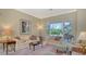 Bright living room featuring plush seating, neutral walls and large sliding glass doors to a screened pool area at 5270 Far Oak Cir, Sarasota, FL 34238