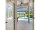 View of a screened-in patio leading to a pool and garden at 5270 Far Oak Cir, Sarasota, FL 34238
